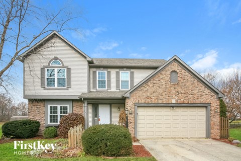 A house with a garage and a driveway is for sale.