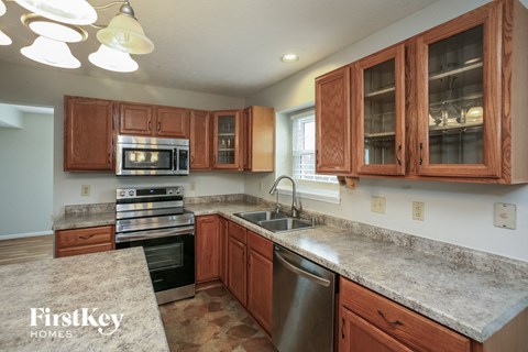 A kitchen with wooden cabinets and granite countertops.