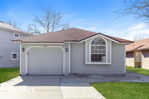 a white house with a white garage door and a window