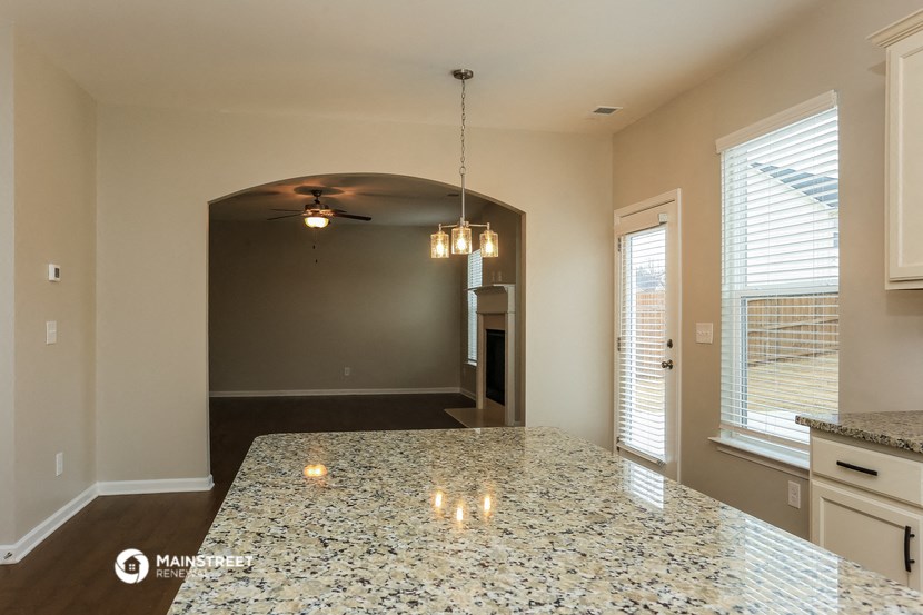 a kitchen with a large island and a living room