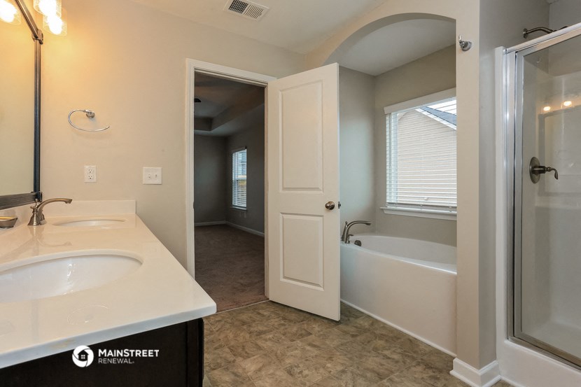 a bathroom with a sink and a shower and a bath tub