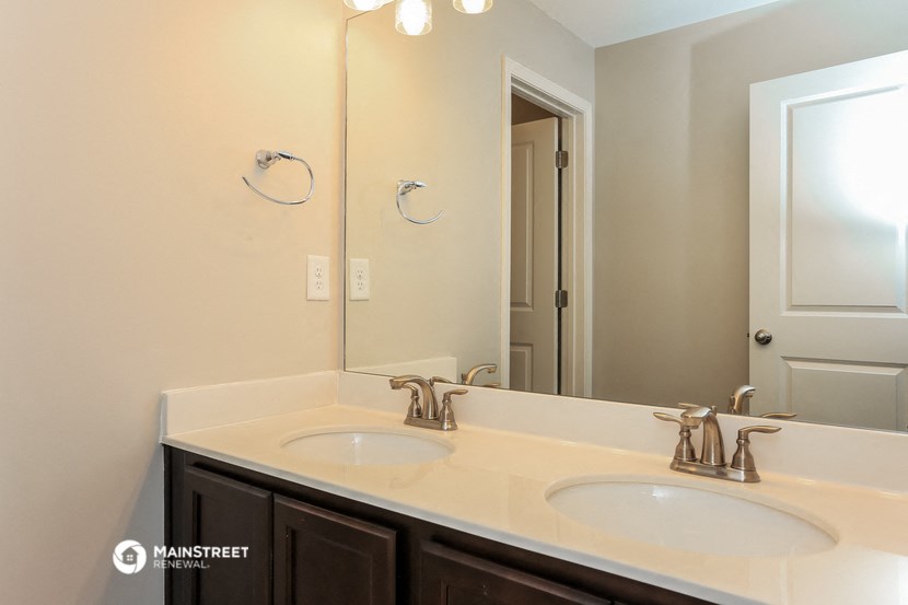 a bathroom with two sinks and a large mirror