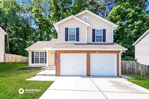 a white house with a garage and a driveway