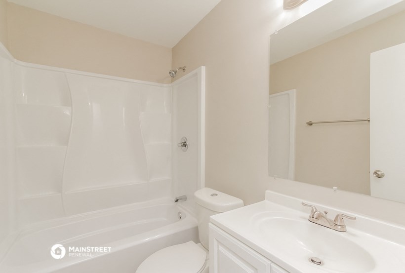 a bathroom with a sink and a toilet and a bath tub