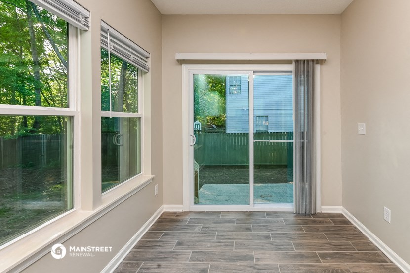 a living room with a sliding glass door to a patio