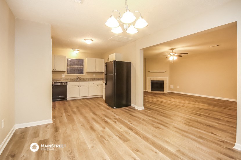 the view of the living room and kitchen from the dining room