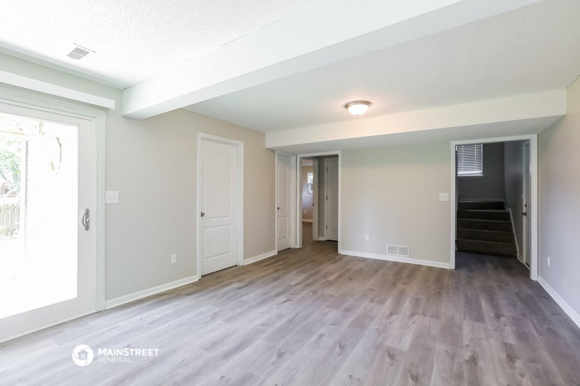 the living room of an apartment with wood flooring