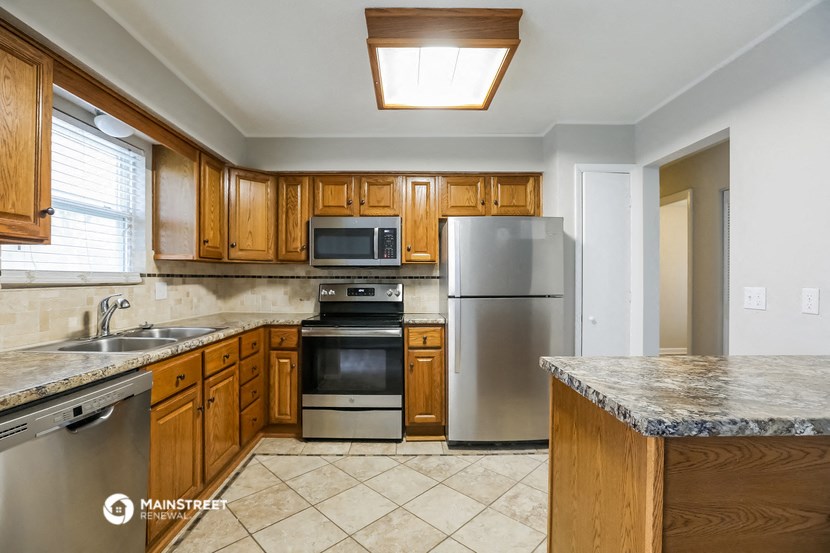 a kitchen with stainless steel appliances and wooden cabinets