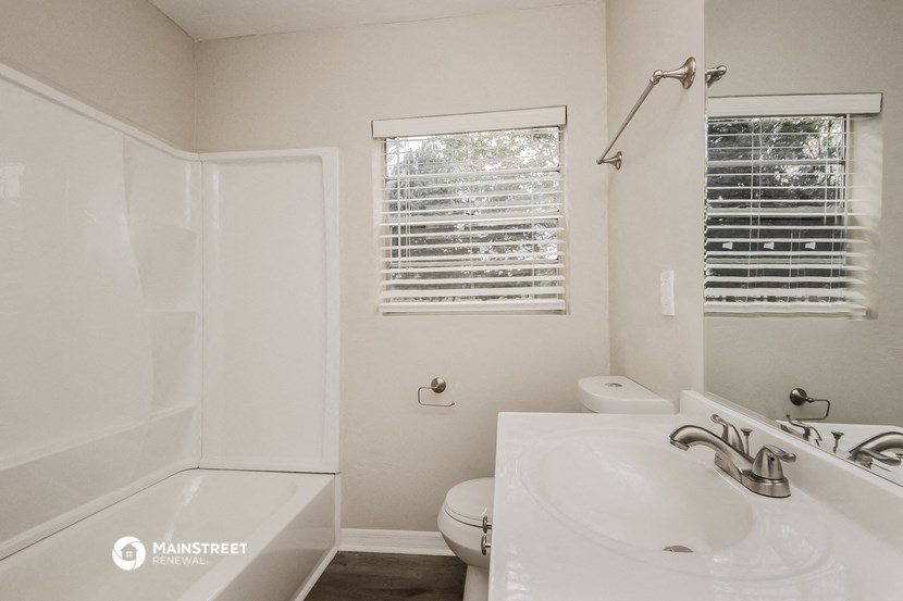 a bathroom with a sink and a tub and a toilet and a shower
