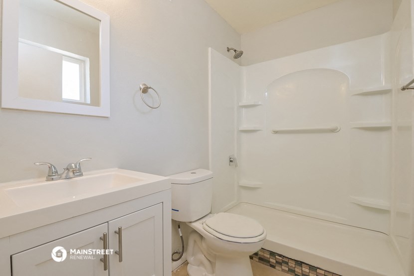 a bathroom with a toilet and a sink and a shower