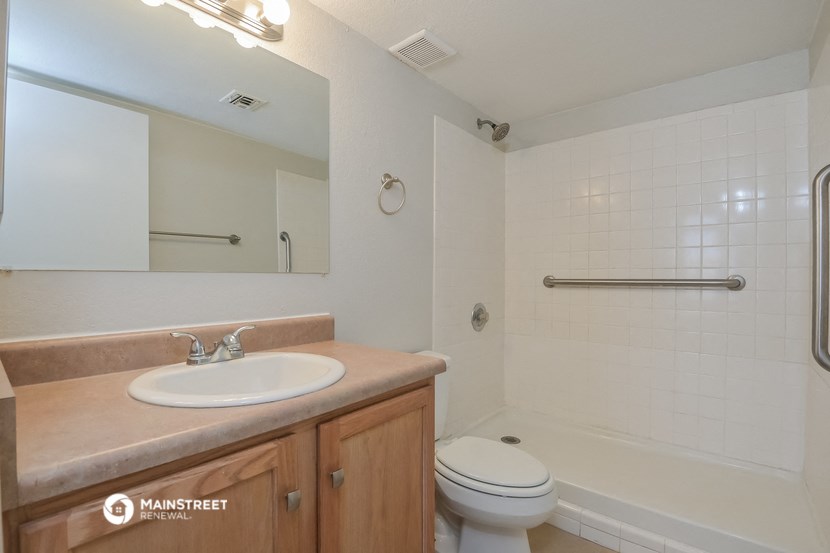 a bathroom with a sink and a toilet and a shower