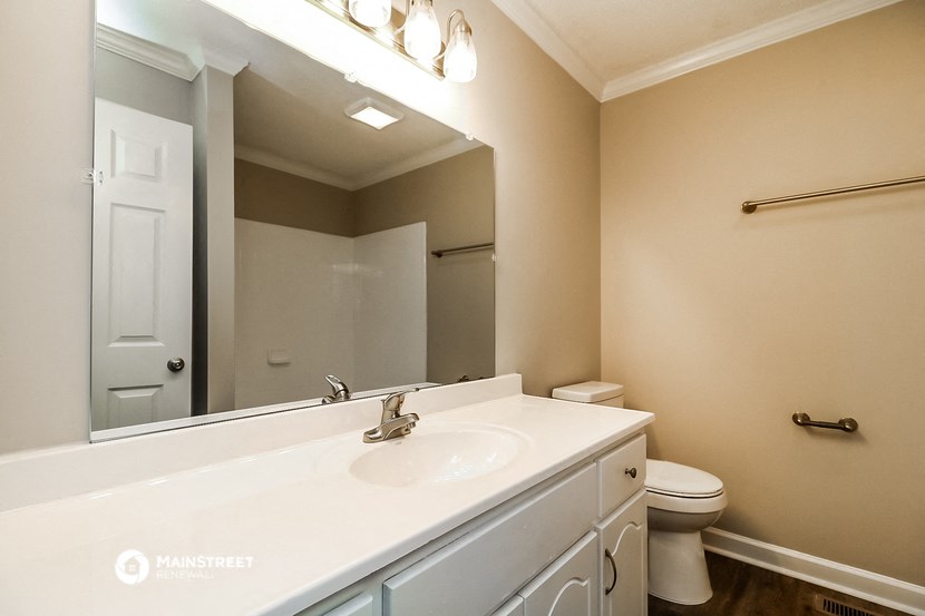 a bathroom with a sink and a toilet and a mirror