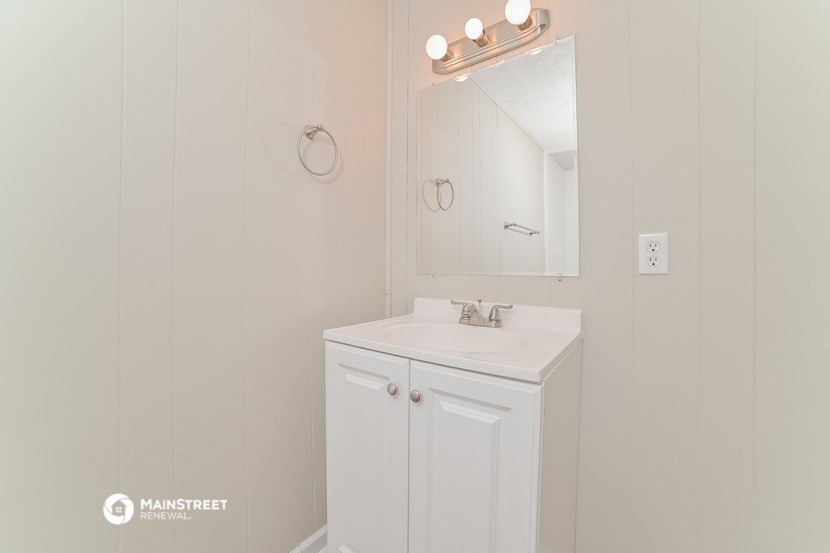 a small bathroom with a sink and a mirror