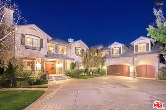 a large house with a driveway and a garage door