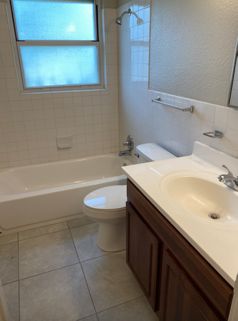 a bathroom with a sink toilet and a bath tub