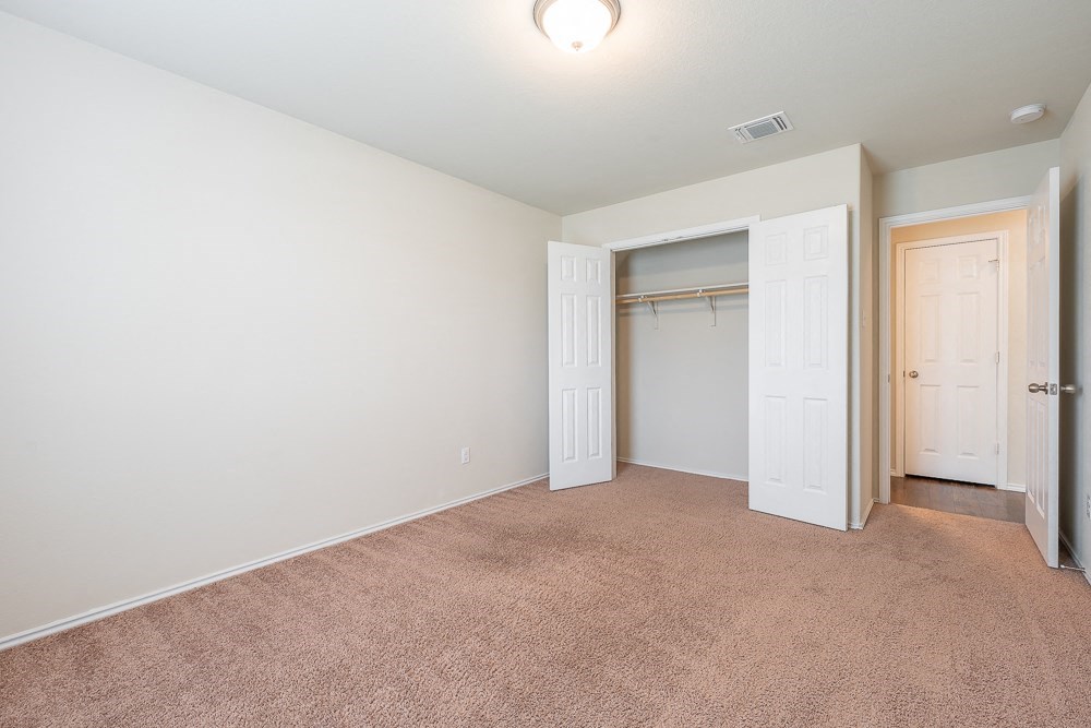 a bedroom with a closet and a door to a closet