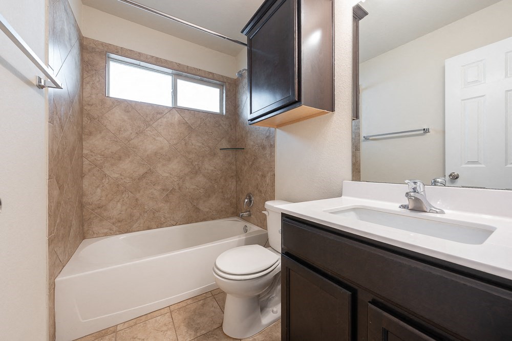 a bathroom with a sink toilet and a bath tub