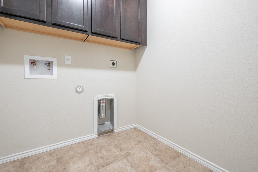 the living room of a home with an electric heater in the corner