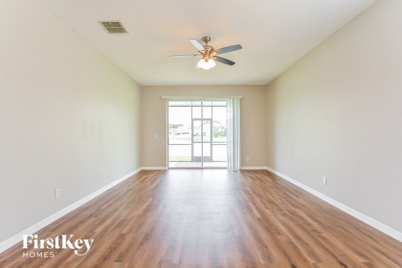 A room with wooden floors and a ceiling fan.