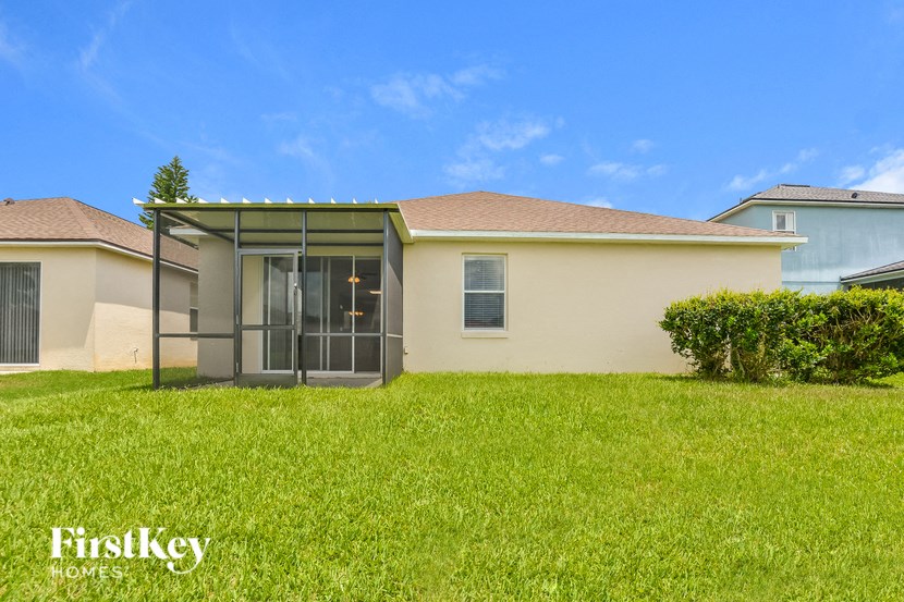 A house with a green lawn and a clear blue sky in the background.