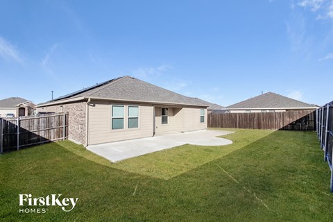 A house with a fence and a grassy yard is for sale.