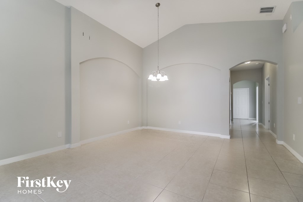 the living room and dining room with the hallway to the bedrooms