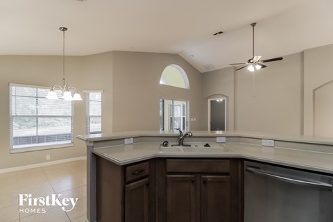 a kitchen with an island and a sink and a window