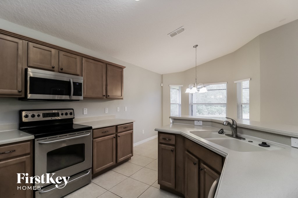 a kitchen with stainless steel appliances and wooden cabinets