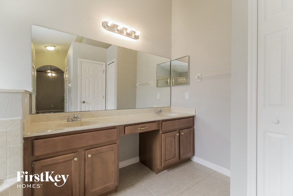a bathroom with two sinks and a large mirror
