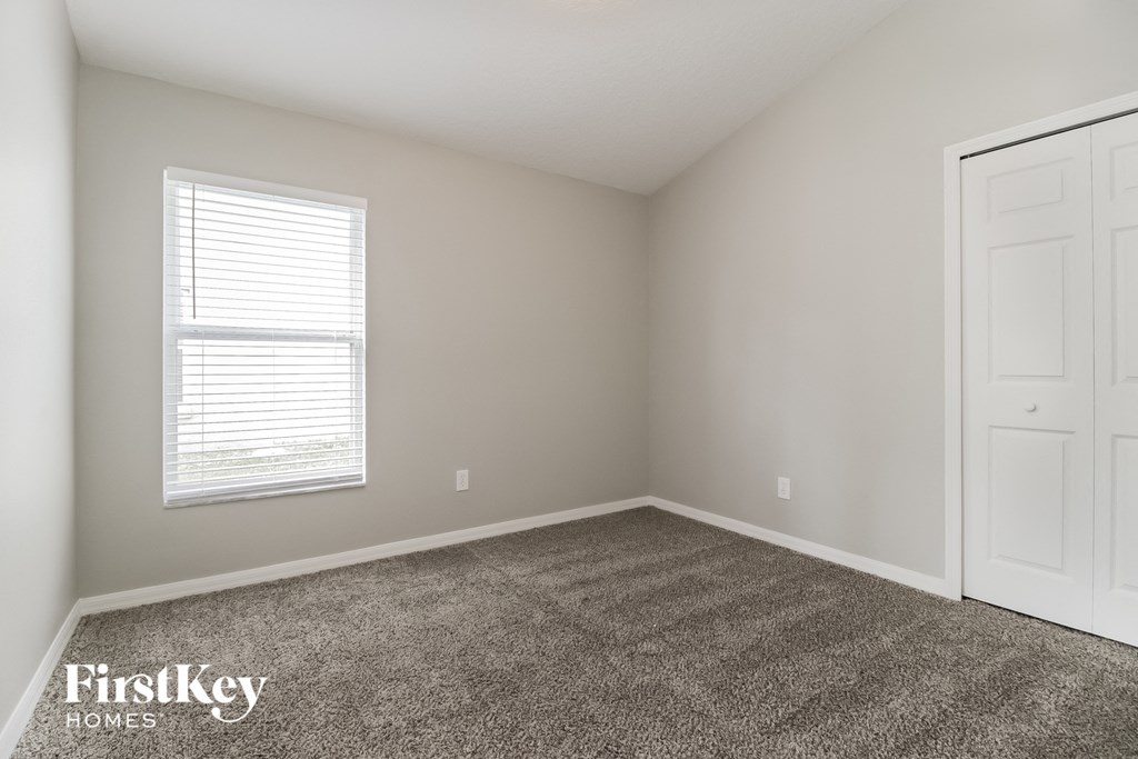 a room with carpet and a window and a door