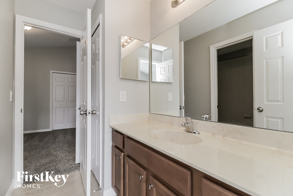 a bathroom with a large mirror and a sink