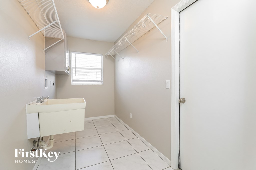 a white bathroom with a sink and a shower in it