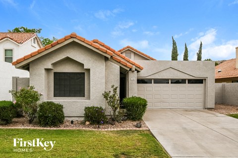 A house with a red tile roof and a garage door.