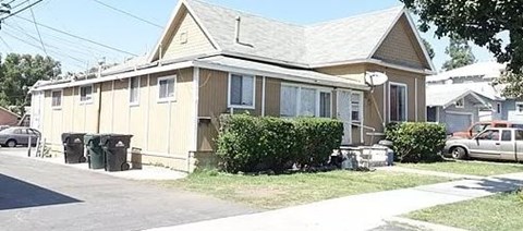 a house with trash cans in front of it