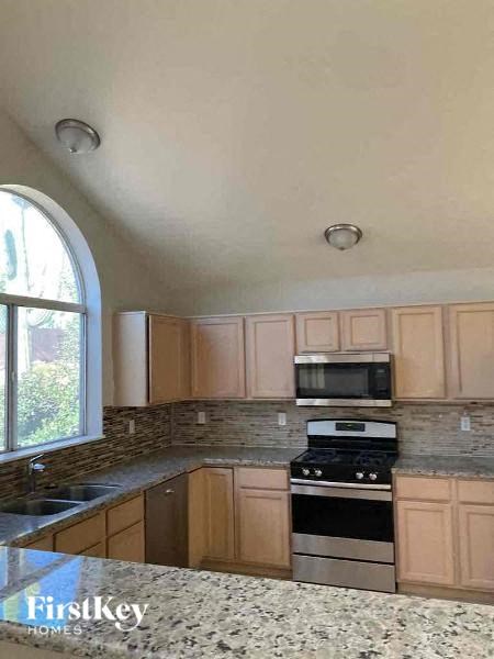 a kitchen with a stove and a microwave
