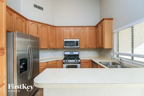 a kitchen with wooden cabinets and stainless steel appliances