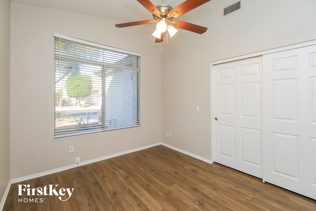 the living room of a home with a ceiling fan and a window