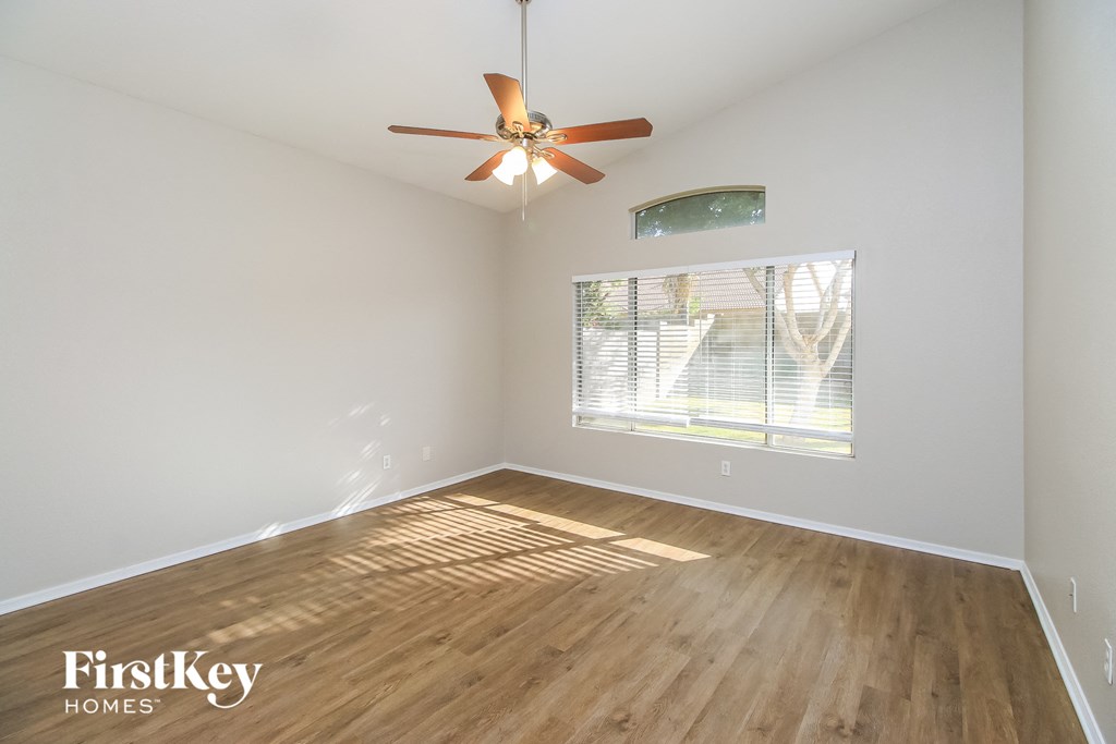 a living room with hardwood floors and a ceiling fan