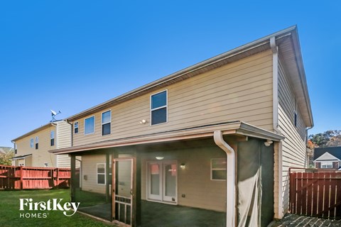 the exterior of a home with a wooden fence and a porch