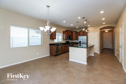 a large kitchen with a white counter top and a large window