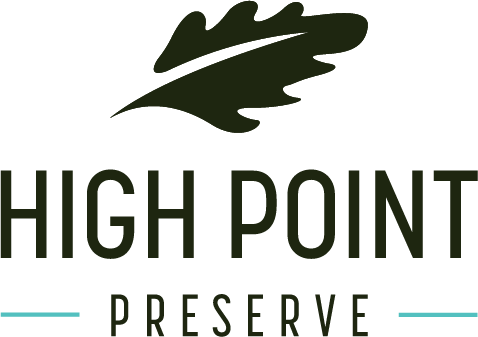 Property entrance sign with oak leaf logo at High Point Preserve Apartments, Austin, TX