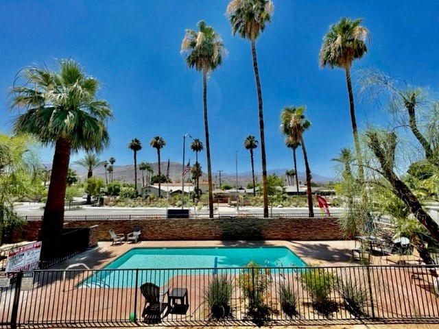 a swimming pool with palm trees in the background