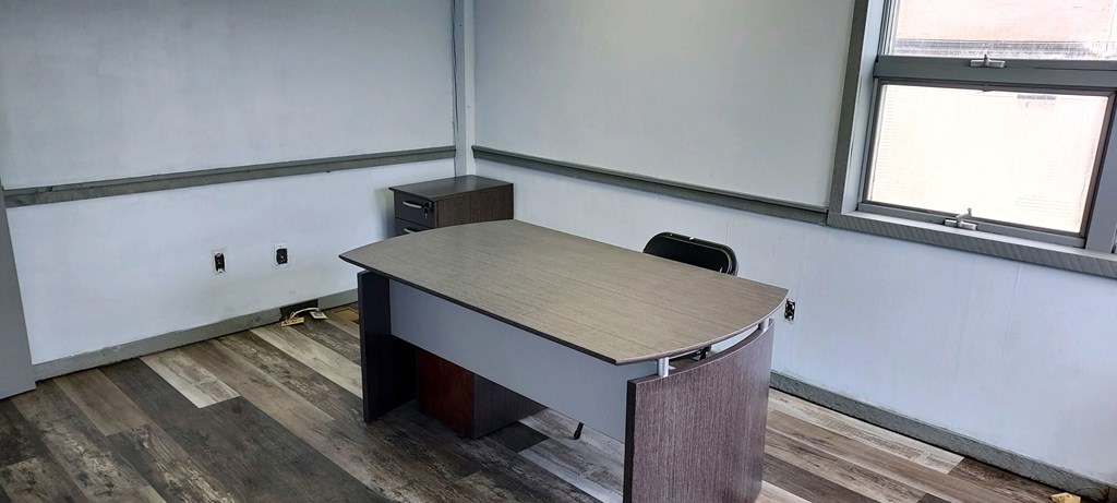 an empty office with a desk and a chair