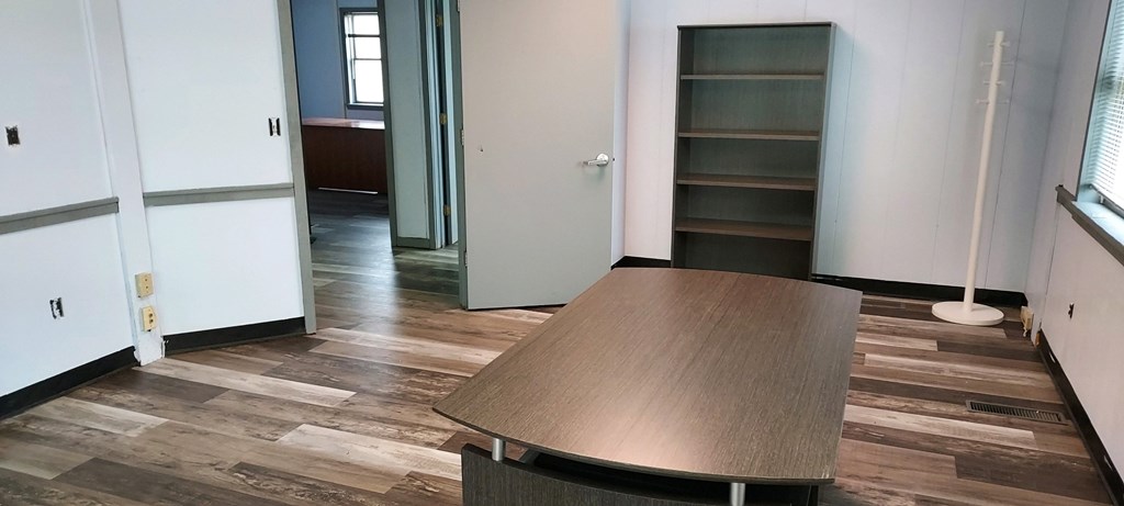 a living room with a wooden table and a closet