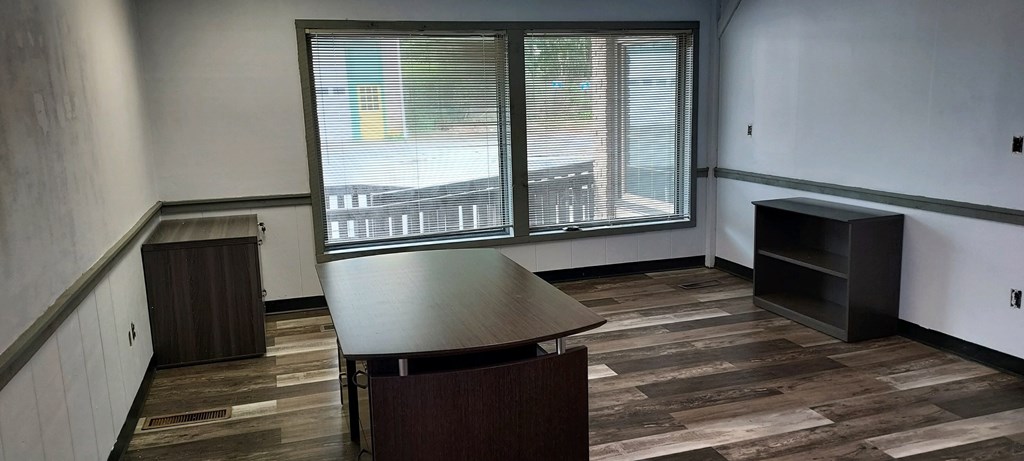 an empty room with a table and a window