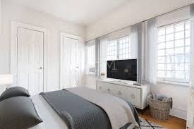 a bedroom with a bed and a television in it