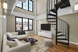 a living room with a spiral staircase and a couch