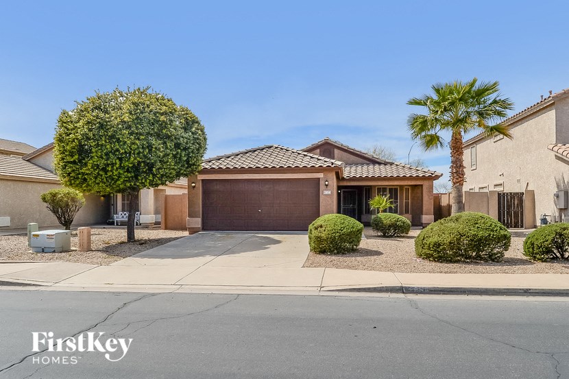 A house with a palm tree in front of it.