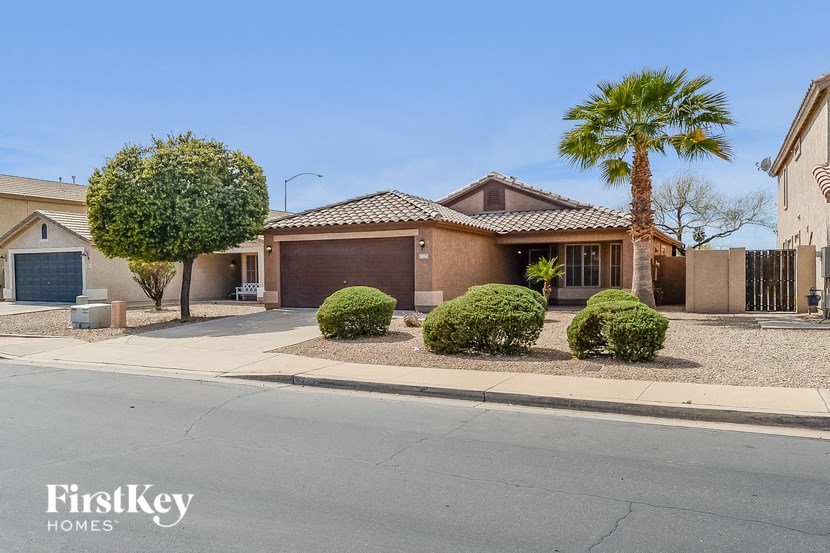 A house with a palm tree in front of it.