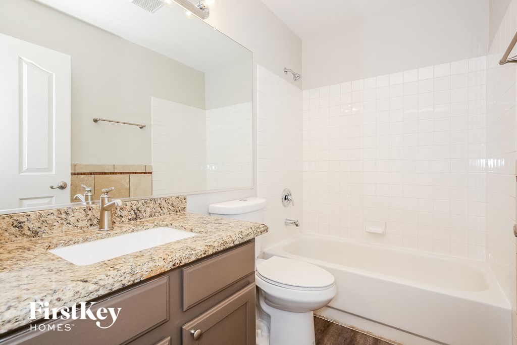 a bathroom with a sink toilet and a bath tub
